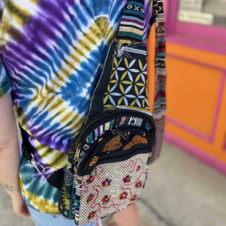 Side view of colorful boho embroidered bag on model