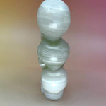Rear view of green onyx triple skull carving