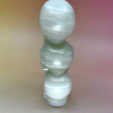 Rear view of green onyx triple skull carving