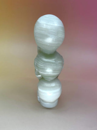 Rear view of green onyx triple skull carving