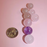 Picture of crystal marbles with quarter or size reference