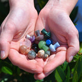 Mini Crystal Gemstone Mushrooms in ladies cupped hands over grass
