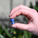 Mini Crystal Gemstone Mushrooms between fingers for size reference