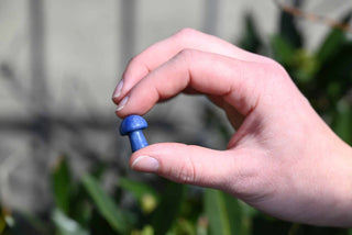 Mini Crystal Gemstone Mushrooms between fingers for size reference