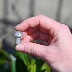 Mini Crystal Gemstone Mushrooms between fingers for size reference