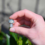 Mini Crystal Gemstone Mushrooms between fingers for size reference