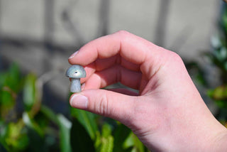 Mini Crystal Gemstone Mushrooms between fingers for size reference