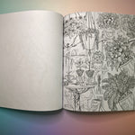 The "Green Witch's Coloring Book" on a pink and blue background, showing off a page.