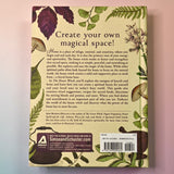 "The House Witch" book on a pink and blue background, showing off the back cover.