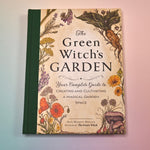 "The Green Witch's Garden" book on a pink and blue background showing the front cover.