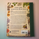 "The Green Witch's Garden" book on a pink and blue background showing the back cover.