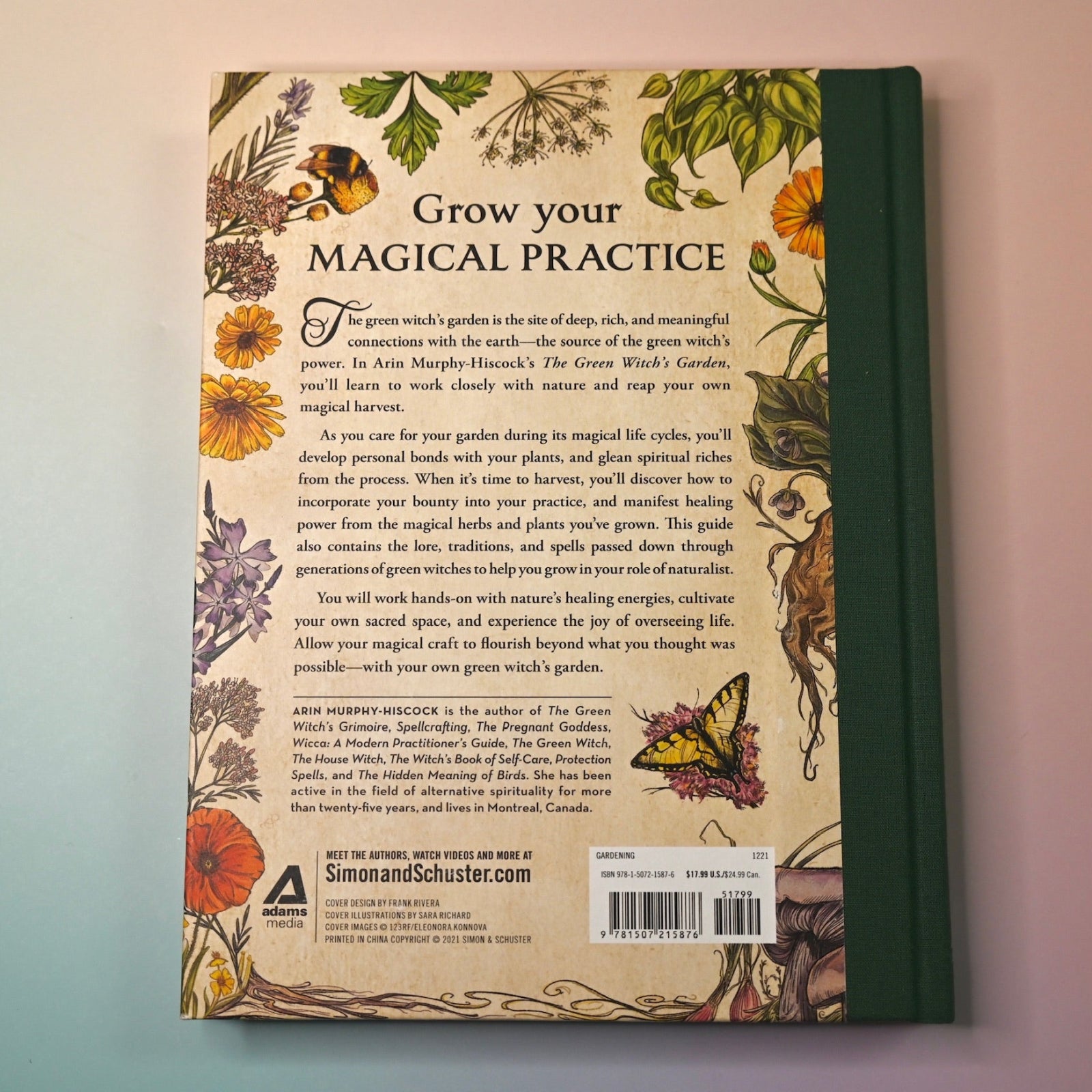 "The Green Witch's Garden" book on a pink and blue background showing the back cover.