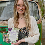 Someone holding the "The House Witch" book.