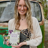Someone holding the "The House Witch" book.