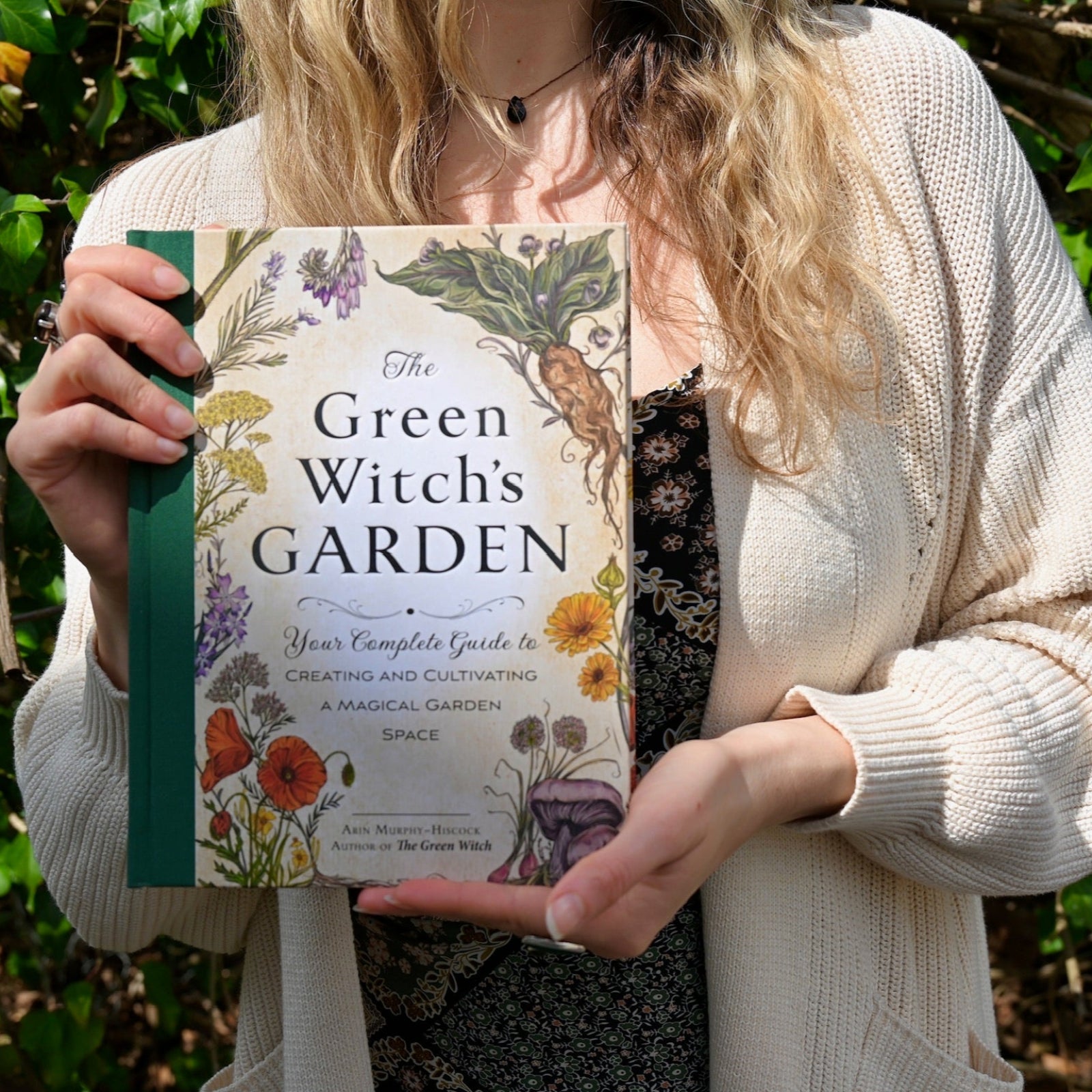 Someone holding the "The Green Witch's Garden" book.