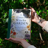 Someone holding the "The Green Witch's Garden" book.