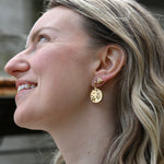 Someone wearing the Vintage Moon & Stars Earrings.