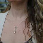 An up-close image of someone wearing the Vintage Silver Scissors Charm Necklace.