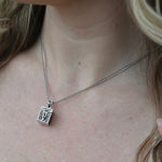 An up-close image of the Vintage Silver Box Locket Necklace being worn.