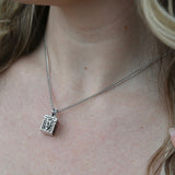 An up-close image of the Vintage Silver Box Locket Necklace being worn.