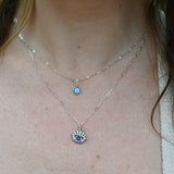 Someone wearing the Sterling Silver Purple Evil Eye Necklace with Paperclip Chain.
