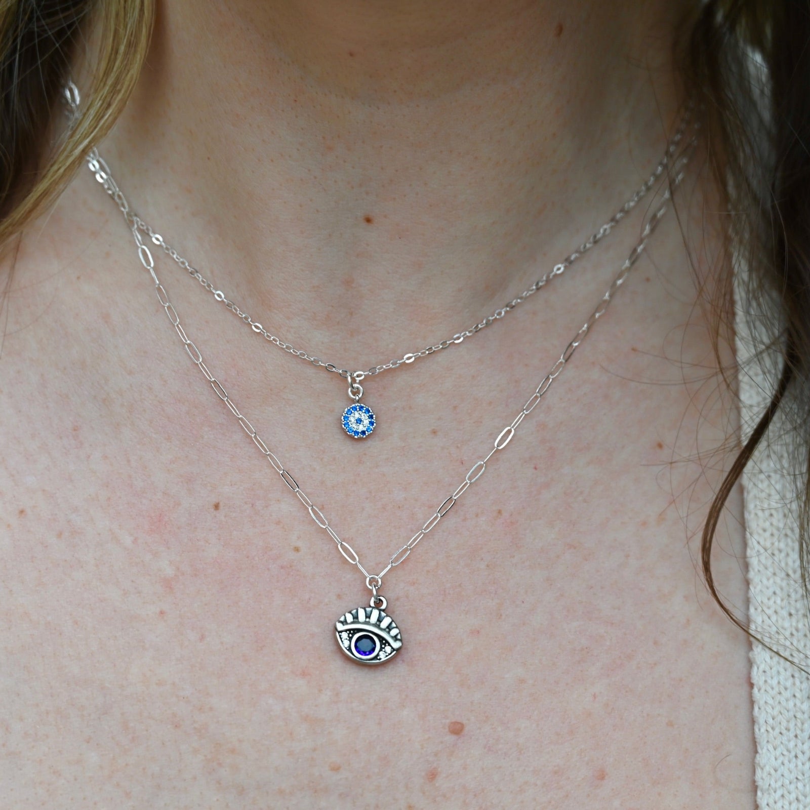 Someone wearing the Sterling Silver Purple Evil Eye Necklace with Paperclip Chain.