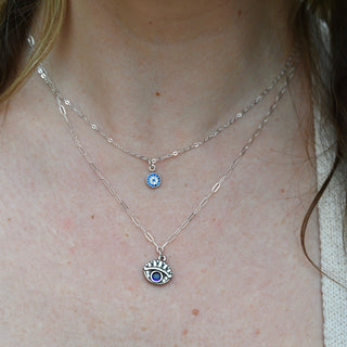 Someone wearing the Sterling Silver Purple Evil Eye Necklace with Paperclip Chain.
