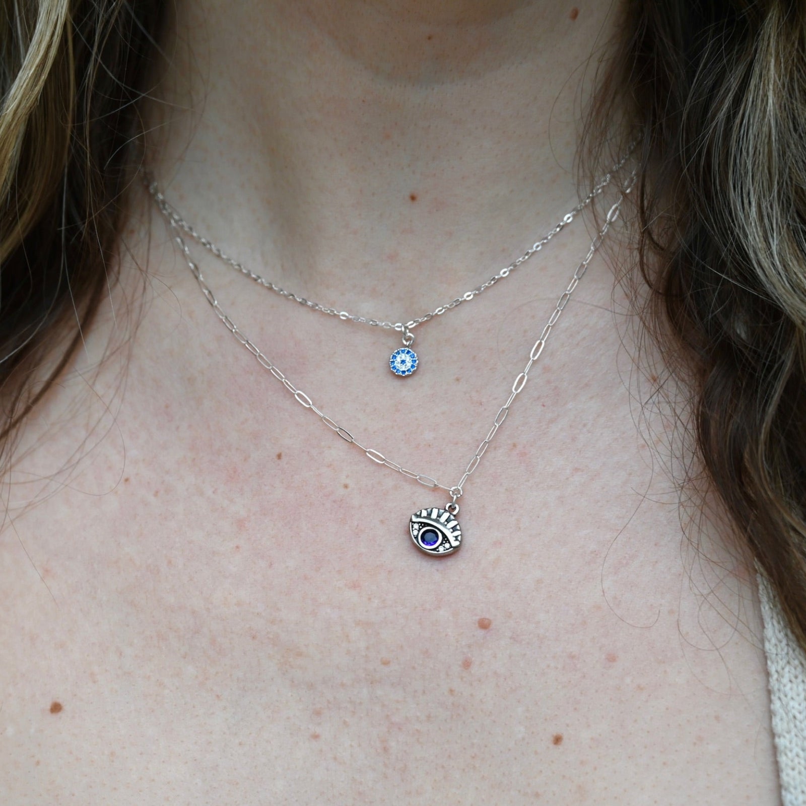 Someone wearing the Sterling Silver Purple Evil Eye Necklace with Paperclip Chain.