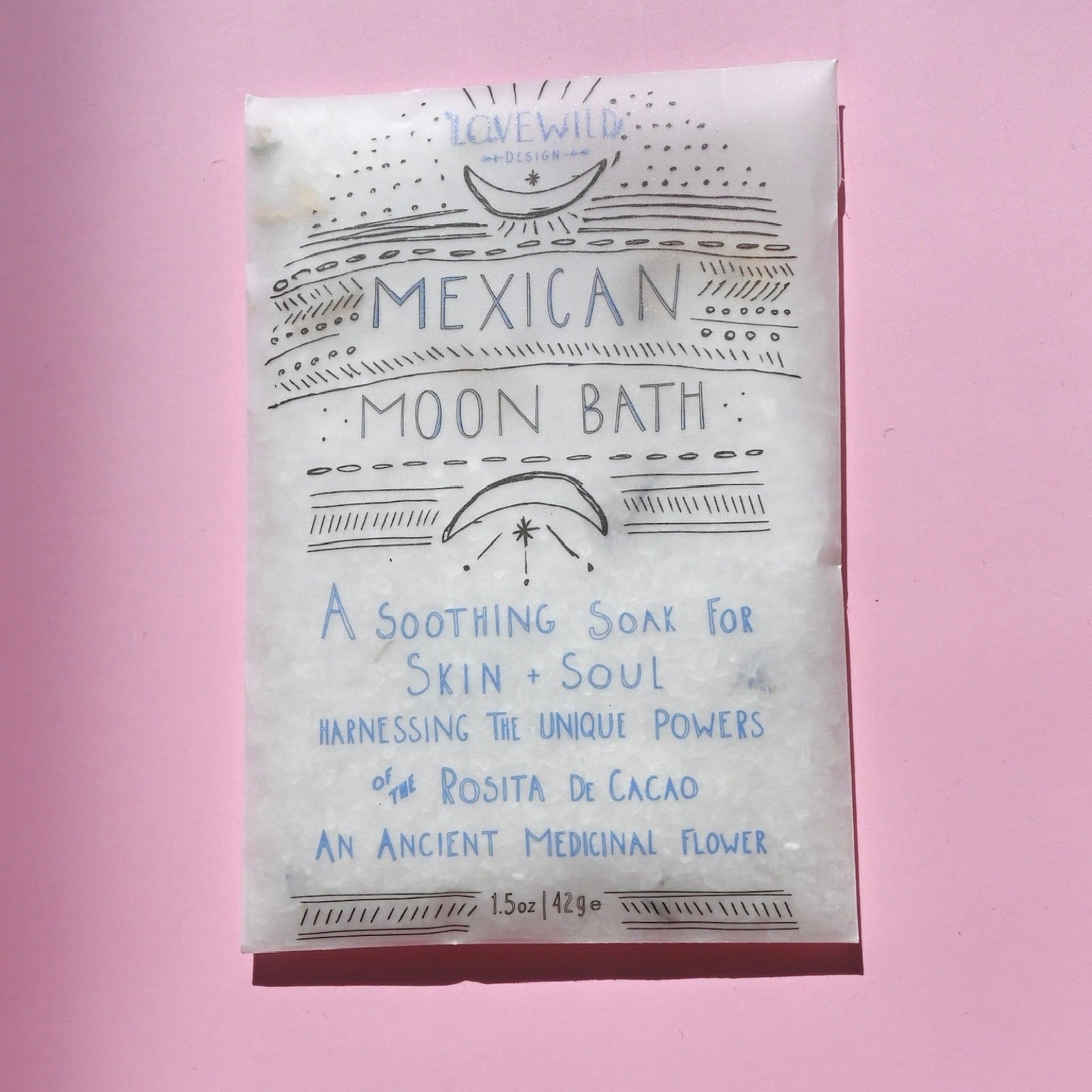 The Mexican Moon Bath Soak Envelope on a pink background.