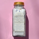 The Mexican Moon Bath Soak on a pink background.