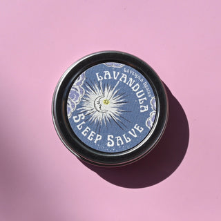 The Lavandula Sleep Salve on a pink background.