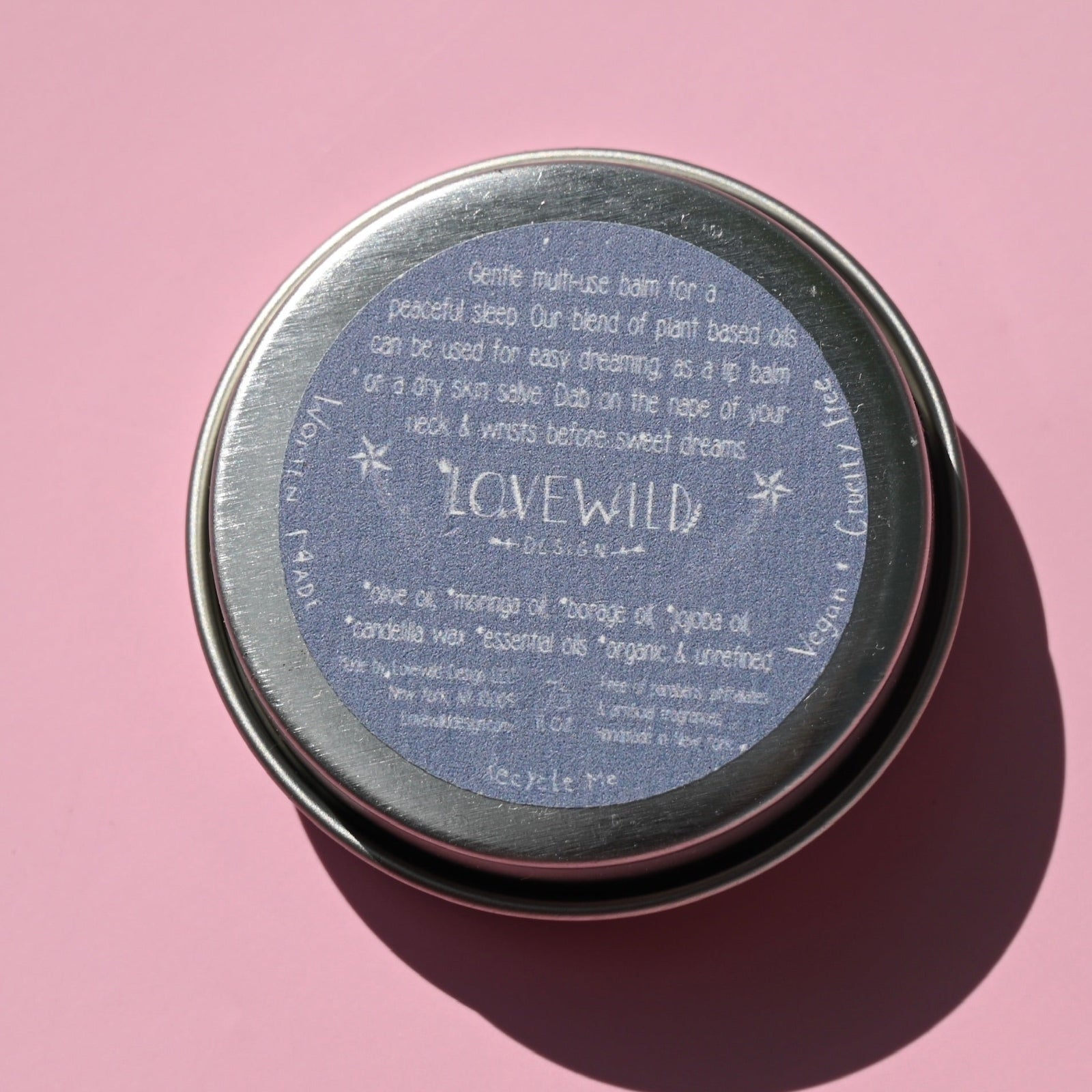 The back of the Lavandula Sleep Salve on a pink background.