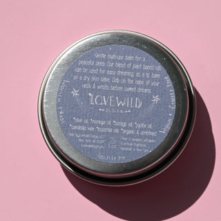 The back of the Lavandula Sleep Salve on a pink background.