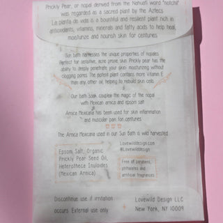 The back of the Sun Bath Medicinal Soak on a pink background.