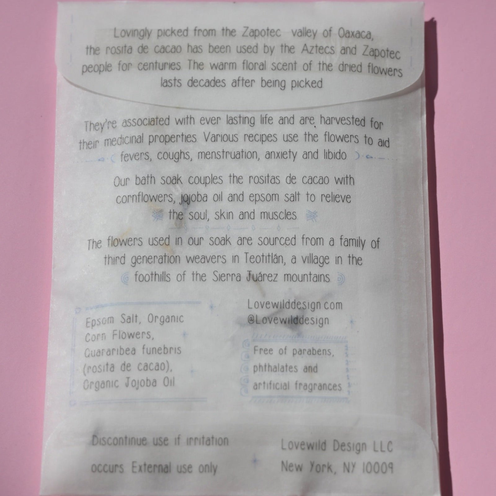 The back of the Mexican Moon Bath Soak Envelope on a pink background.