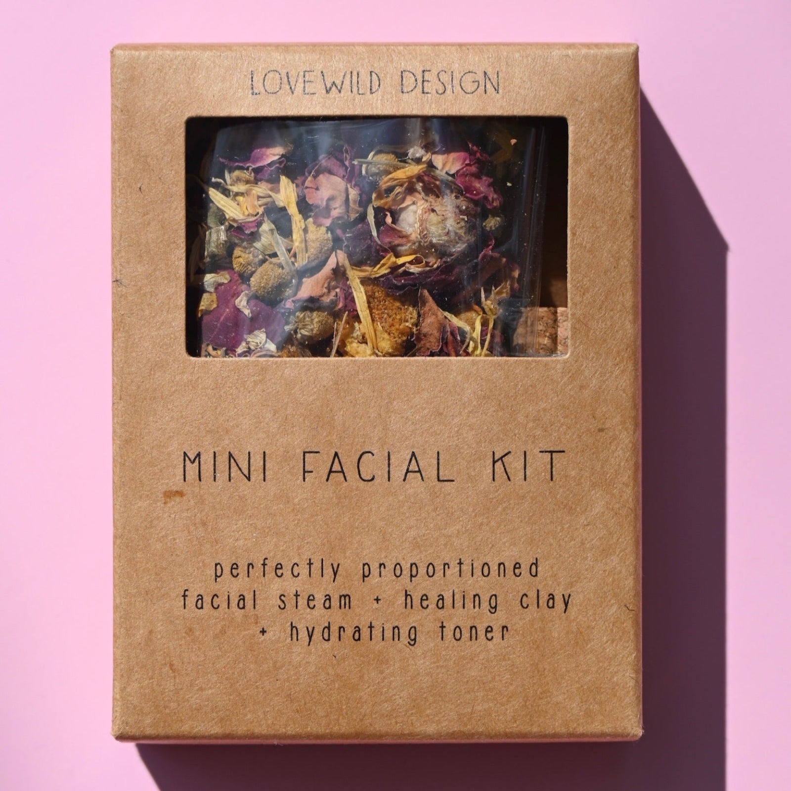 The Mini Facial Kit on a pink background.