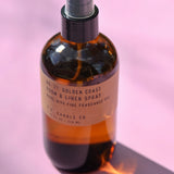 The P.F. Candle Co. - Golden Coast - 7.75 fl oz Room & Linen Spray on a pink background.