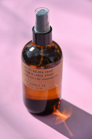 The P.F. Candle Co. - Golden Coast - 7.75 fl oz Room & Linen Spray on a pink background.