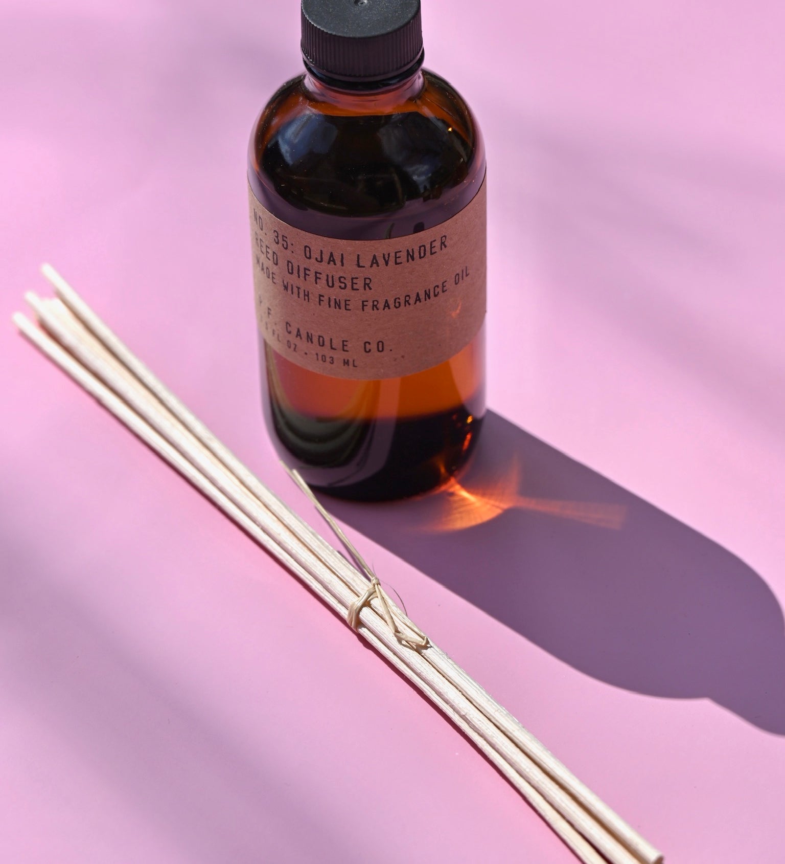 The P.F. Candle Co. Ojai Lavender - 3.5 oz Reed Diffuser on a pink background
