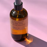 The P.F. Candle Co. - Ojai Lavender - 7.75 fl oz Room & Linen Spray on a pink background.