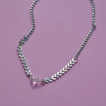 The Clear Quartz Stainless Steel Vibez Choker on a purple background.