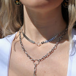 Someone wearing the Clear Quartz Vibez Choker and the Garnet Priestess Y Necklace.