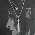 The Stainless Steel Moonstone Sword Necklace and Moonstone Sterling Silver Celestial Necklace being worn by someone.