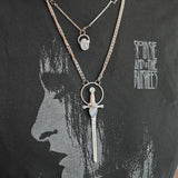 The Stainless Steel Moonstone Sword Necklace and Moonstone Sterling Silver Celestial Necklace being worn by someone.