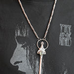 Someone wearing the Sterling Silver Prehnite Sword Necklace.