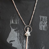 Someone wearing the Sterling Silver Prehnite Sword Necklace.