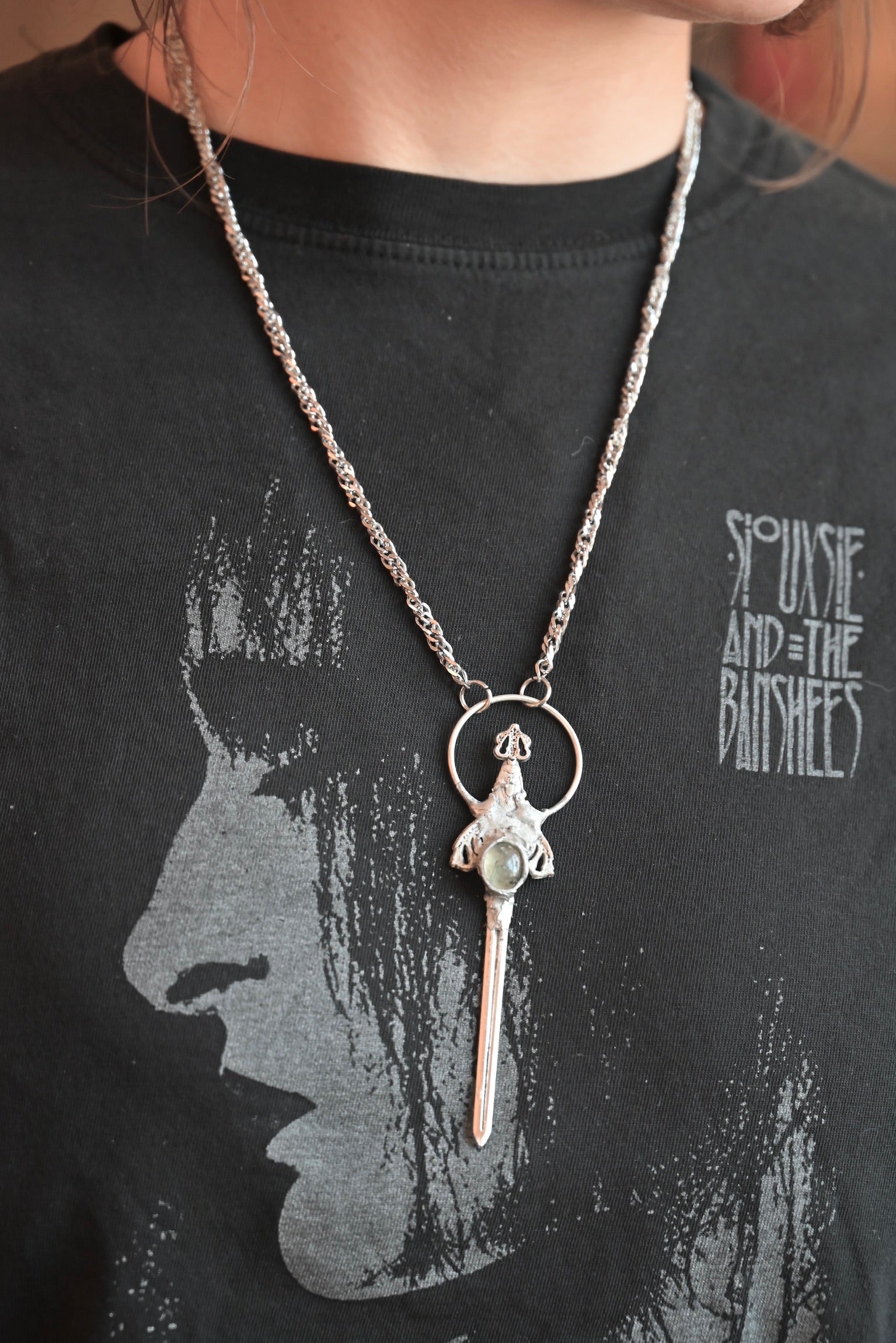 Someone wearing the Sterling Silver Prehnite Sword Necklace.