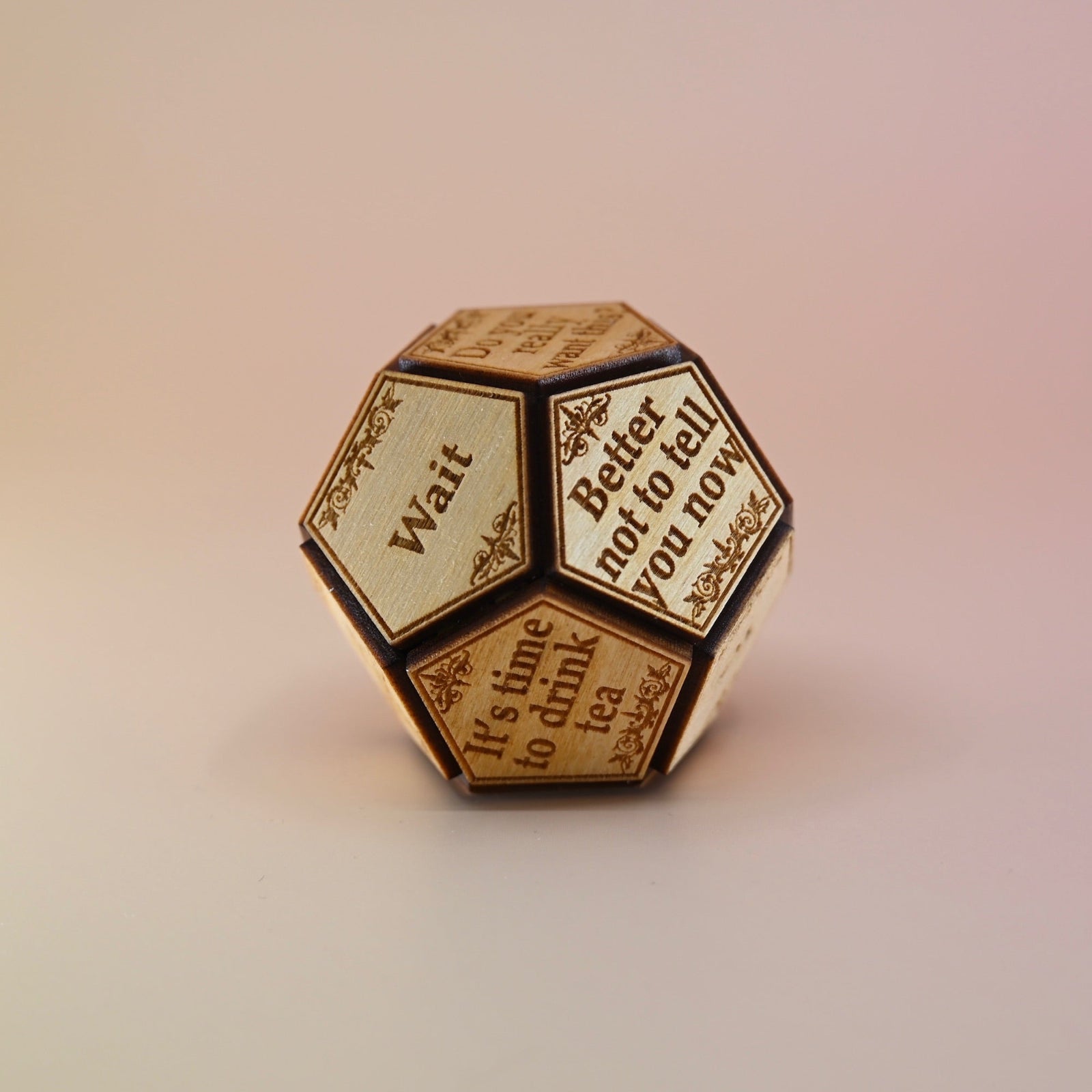 The Twelve Sided Single Divination Dice on a pink background.