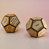 Two of the Twelve Sided Single Divination Die on a pink background.