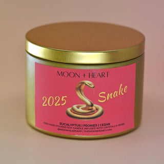 The Year of the Snake Intention & Manifestation Candle - Chinese Zodiac Candle on a pink background.